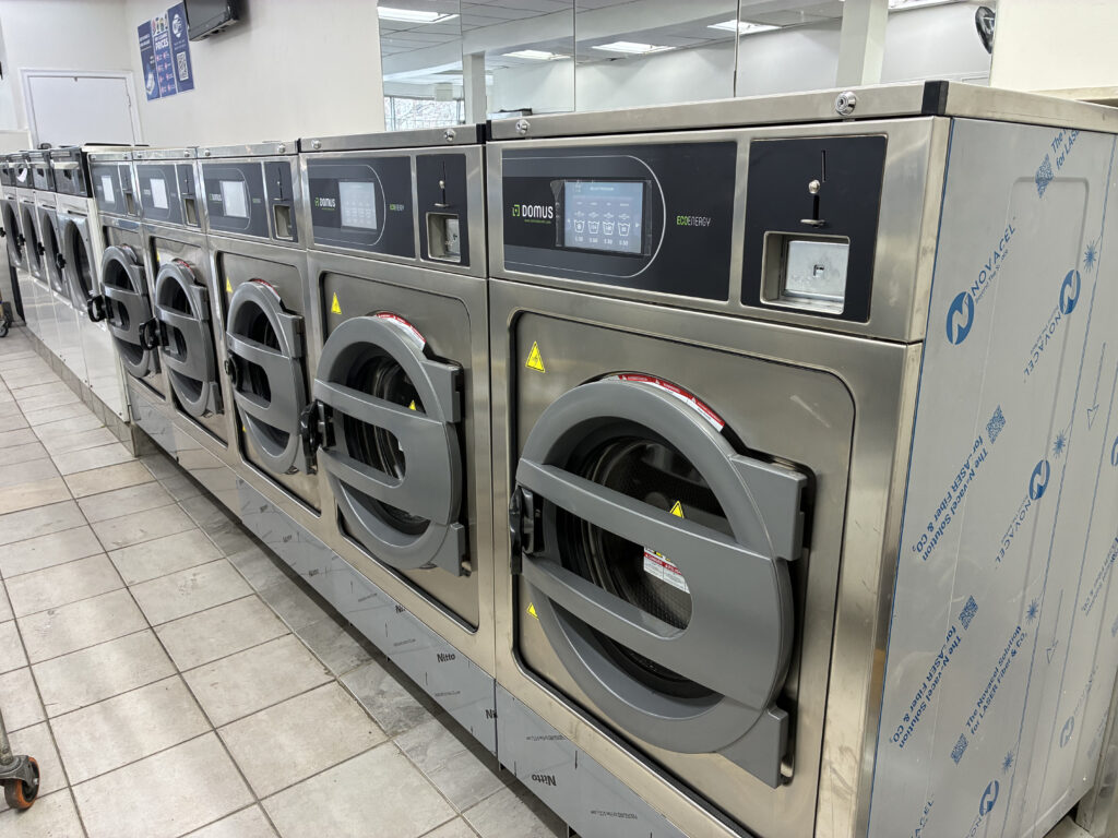 Row of Domus washers at Jane Coin Laundry